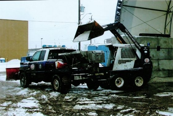 East-West salting truck applying de-icing material to a Toronto commercial parking lot