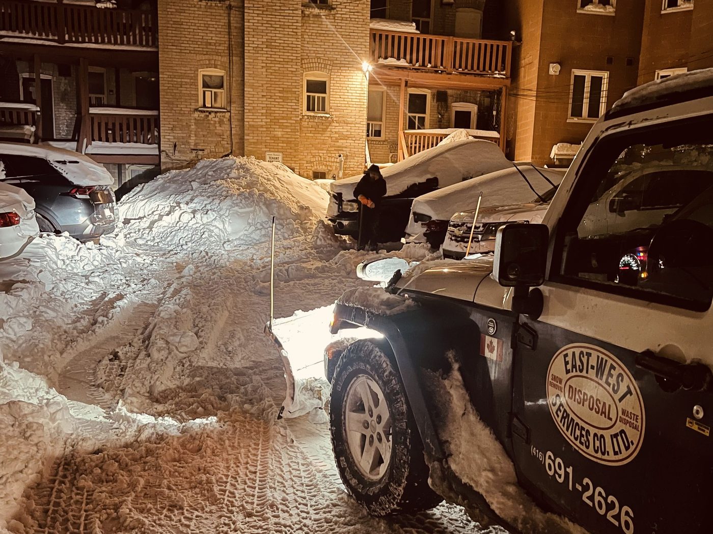 East-West truck stacking and relocating accumulated snow at a Toronto multi-residential property